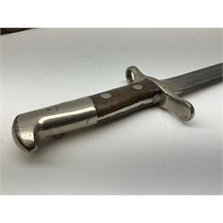 British Enfield 1907 model SMLE bayonet, with 43cm fullered steel blade and metal mounted leather scabbard L58cm overall; and Schmidt-Rubin Model 1918 bayonet the 30cm steel blade marked Elsener Schwyz No.579722; in steel scabbard with leather frog marked G. Bertolini Sellaio Vira/G.Tic 79 L45cm overall (2)