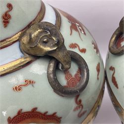 Pair of early 20th century Chinese vases decorated with dragons chasing a flaming pearl, with a gilt border of butterflies and floral sprigs, with Elephant head handles, H44cm 