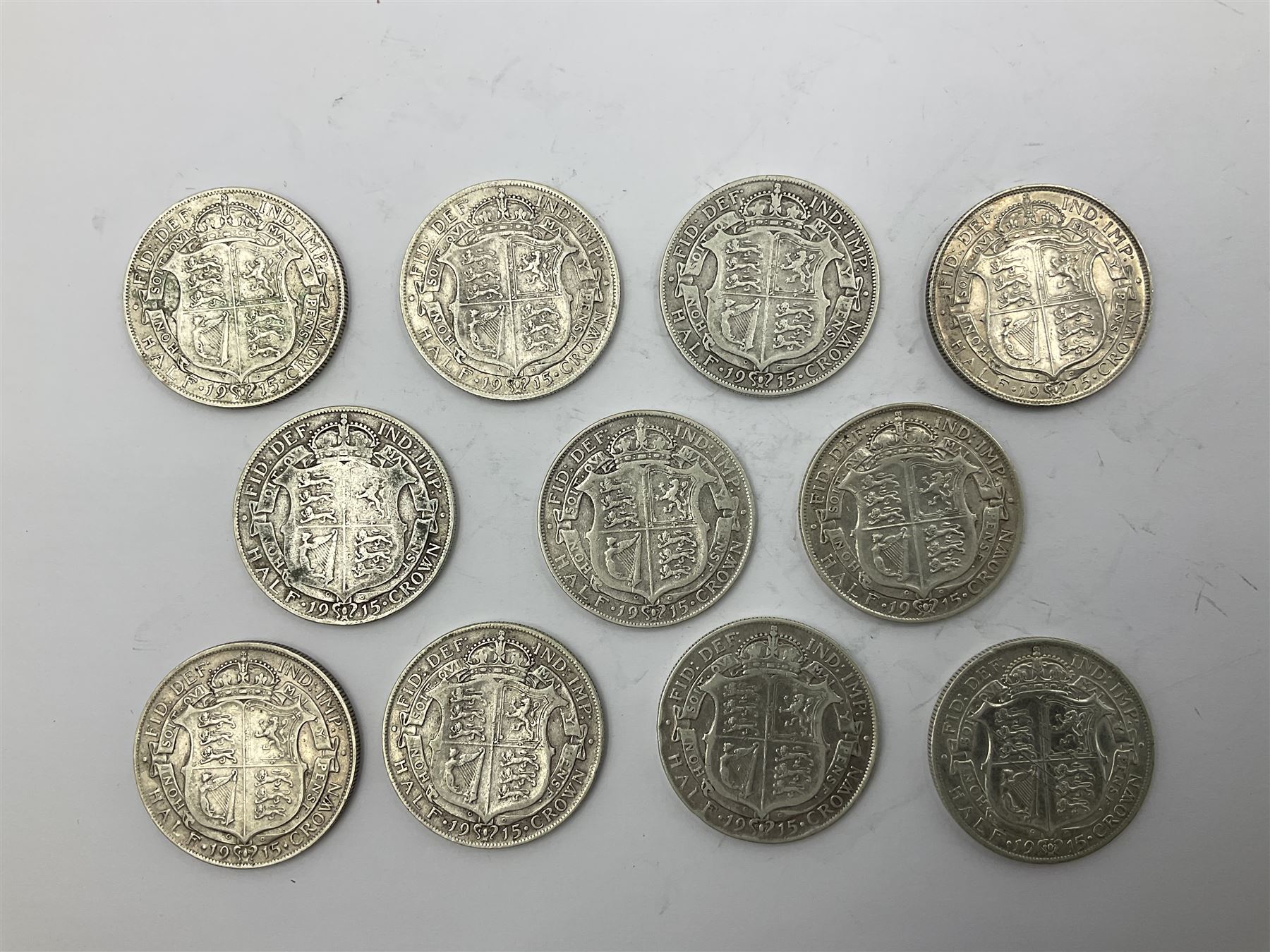 Eleven King George V 1915 silver half crown coins