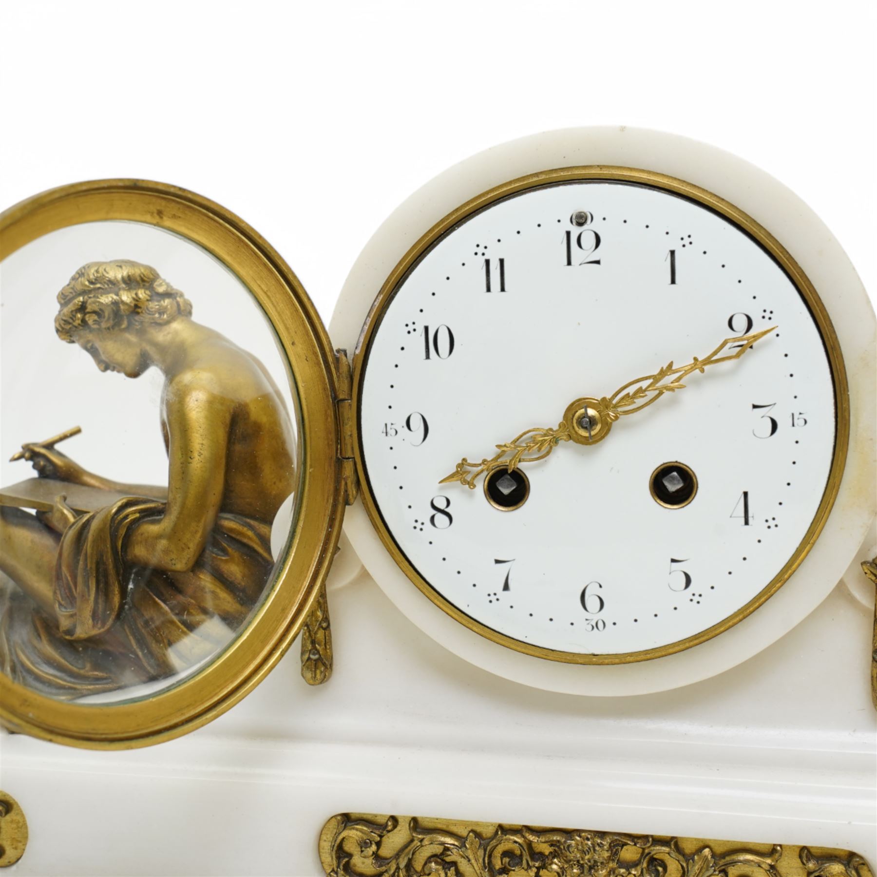 French- Fine early 20th century 8-day white marble mantle clock, on a rectangular stepped plinth with recessed brass banding and inset oval brass panels with raised scroll and leaf decoration, drum cased Parisian  movement flanked by a pair of seated cast brass figures taken from classical antiquity, with a convex white enamel dial and glazed cast brass bezel, Arabic numerals and minute markers with matching pierced brass hands, twin train going barrel movement with a recoil anchor escapement and rack striking, sounding the hours and half hours on a bell. With pendulum.  