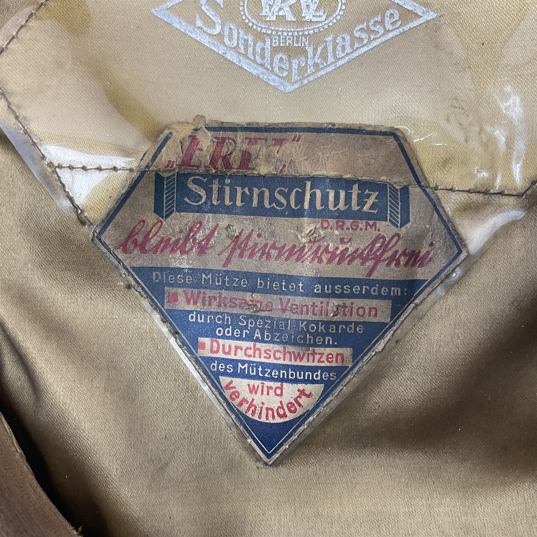 WW2 German Infantry Officer's visor cap with cloth insignia; labelled and stamped Offizier Kleiderkasse Berlin and Erel Stirnschutz