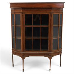 Edwardian inlaid mahogany display cabinet of rectangular canted form, galleried top with crossbanded inlay, above a glazed cabinet enclosing  baize lined shelves, raised on square tapering legs terminating in spade feet  