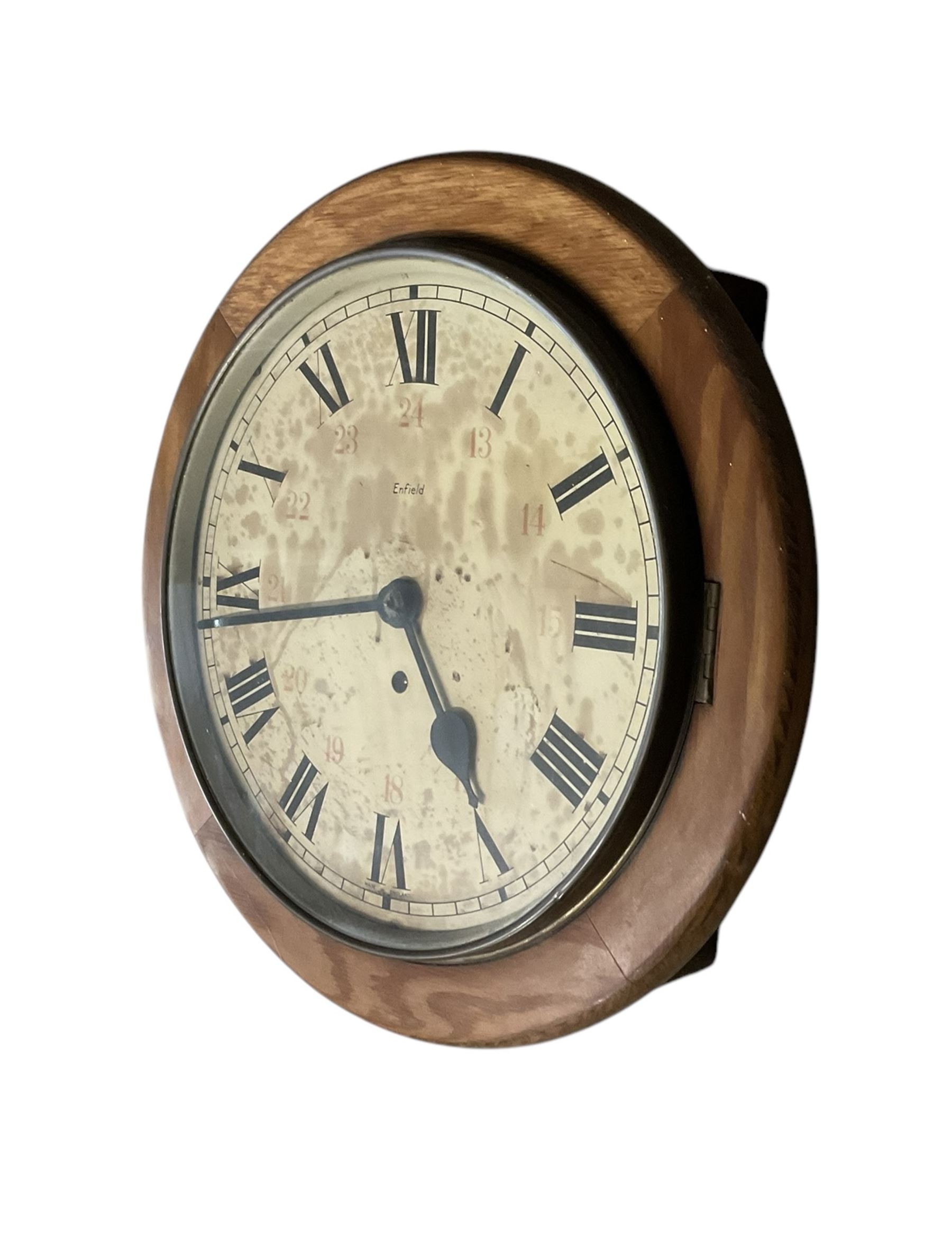 12” Enfield spring driven wall clock with a  12 and 24 hour dial.
