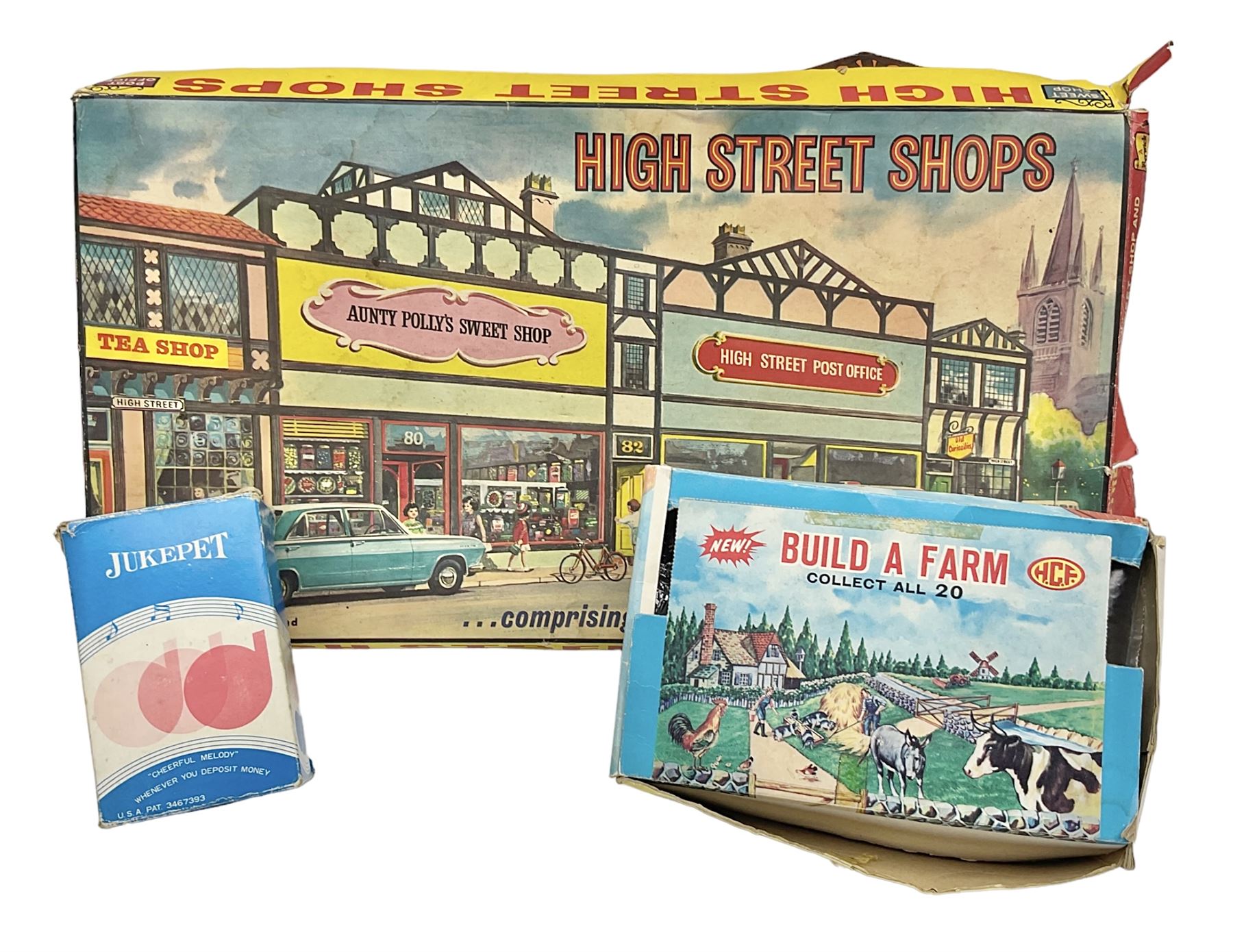 Berwick Toys High Street Shops layout with well-stocked sweet shop and post office; H.C.F. Build A Farm set; and Jukepet battery operated miniature jukebox; all boxed (3)