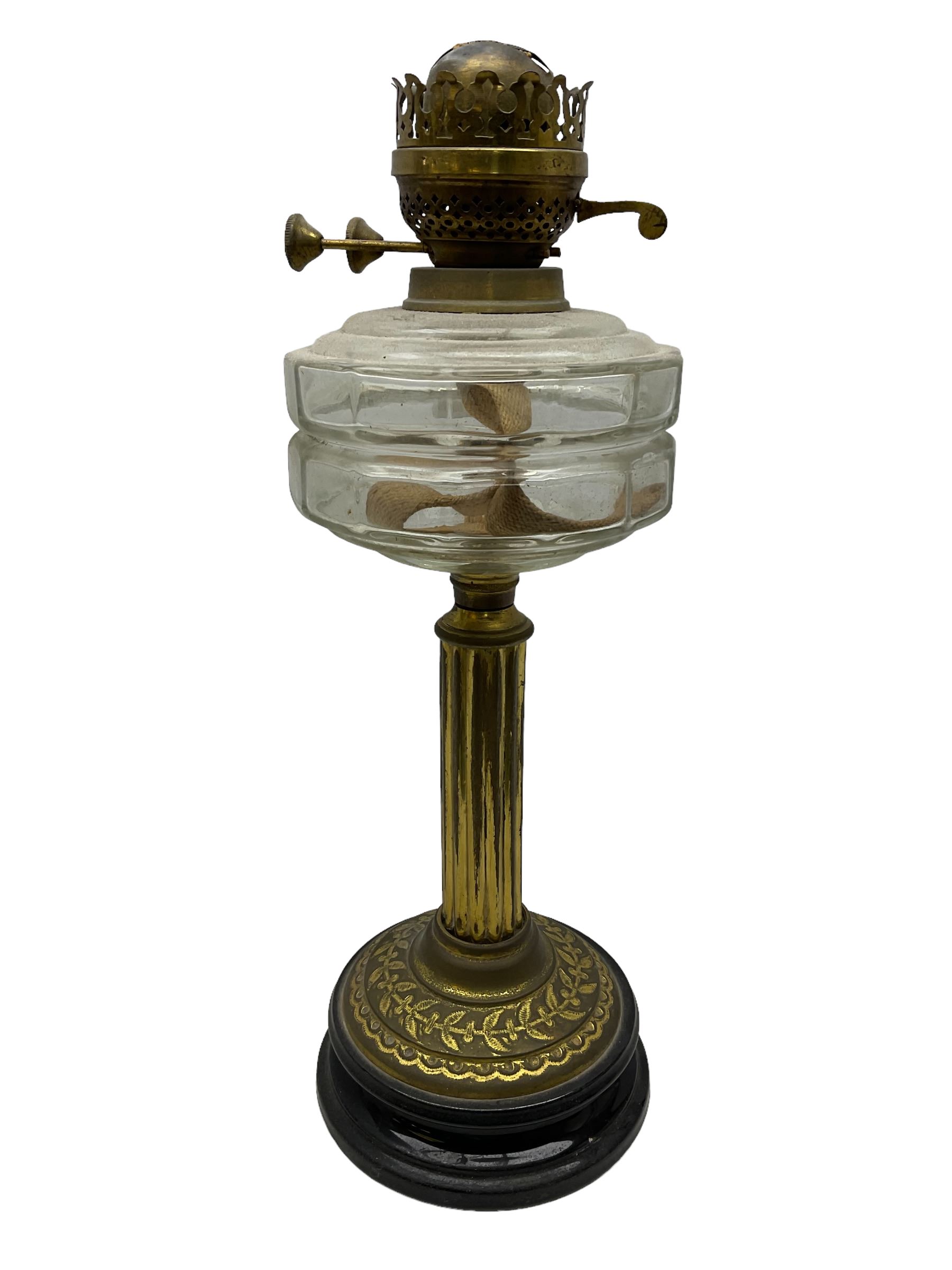 Early 20th century brass oil lamp with ornate foliate base and clear glass reservoir, H46cm