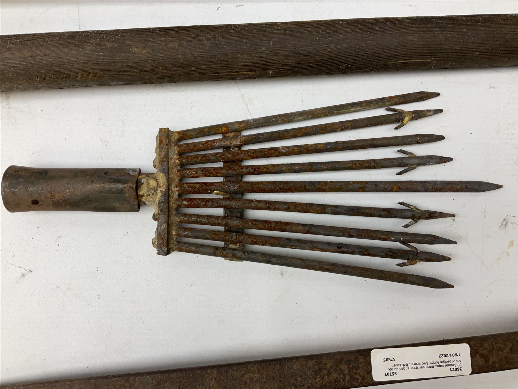 Blue and red painted gas powered bird / pest scarer, bearing label 'Exid bird & pest scarer, imported by C.R.E.A.C.O Hadleigh, Essex', , copper and brass Cymag gas hand pump, three eel spears and a set of badger tongs. Auctioneer's Note: These traps are sold as artefacts for ornamental purposes only as the use of some of them is illegal.