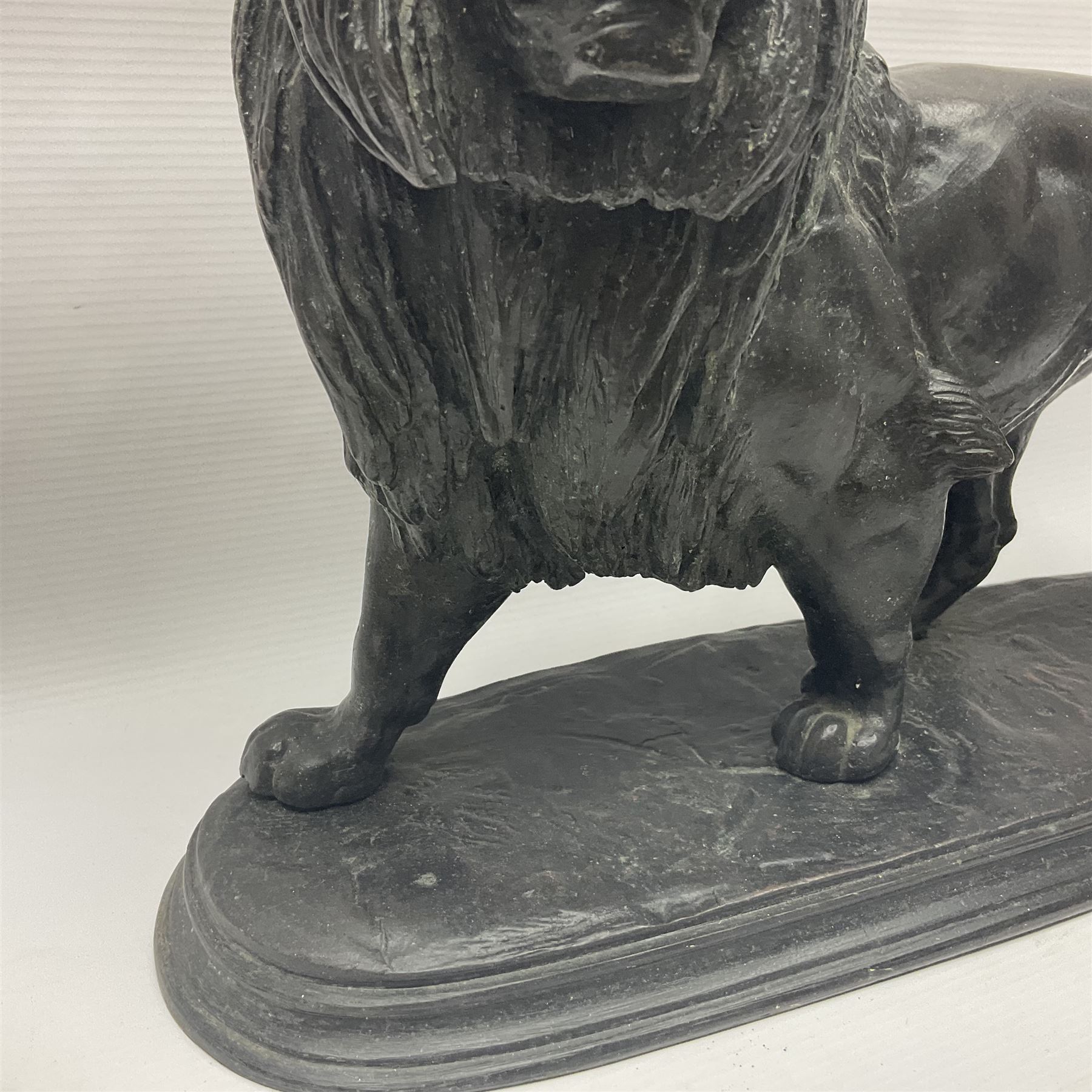After Paul Edouard Delabrierre (French, 1829-1912), bronze, model of a lion, upon an oval base, signed E Delabrierre, overall H29.5cm, L46cm