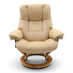 Ekornes Stressless - beech framed reclining swivel armchair with matching footstool, on U-shaped supports with circular bases, upholstered in beige leather