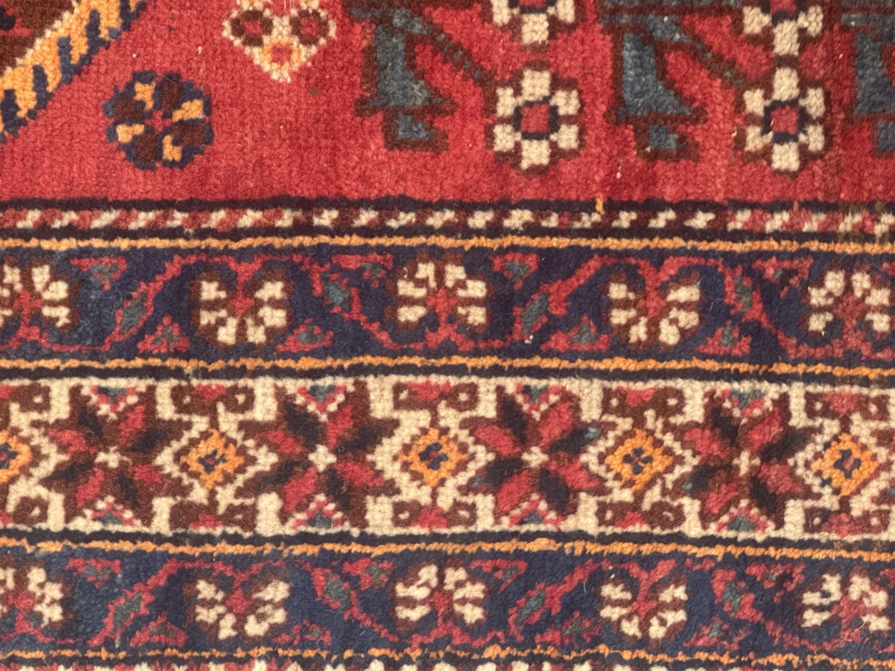 Persian Heriz wool rug, red and ivory field with floral medallion, geometric spandrels, and floral border (157cm x 107cm); Kurdish Shairwan wool rug, red and navy field with three medallions, geometric crosses and serrated border (200cm x 155cm); Persian Qashqai wool rug, golden-yellow field with boteh motifs and wide floral border (127cm x 82cm)
