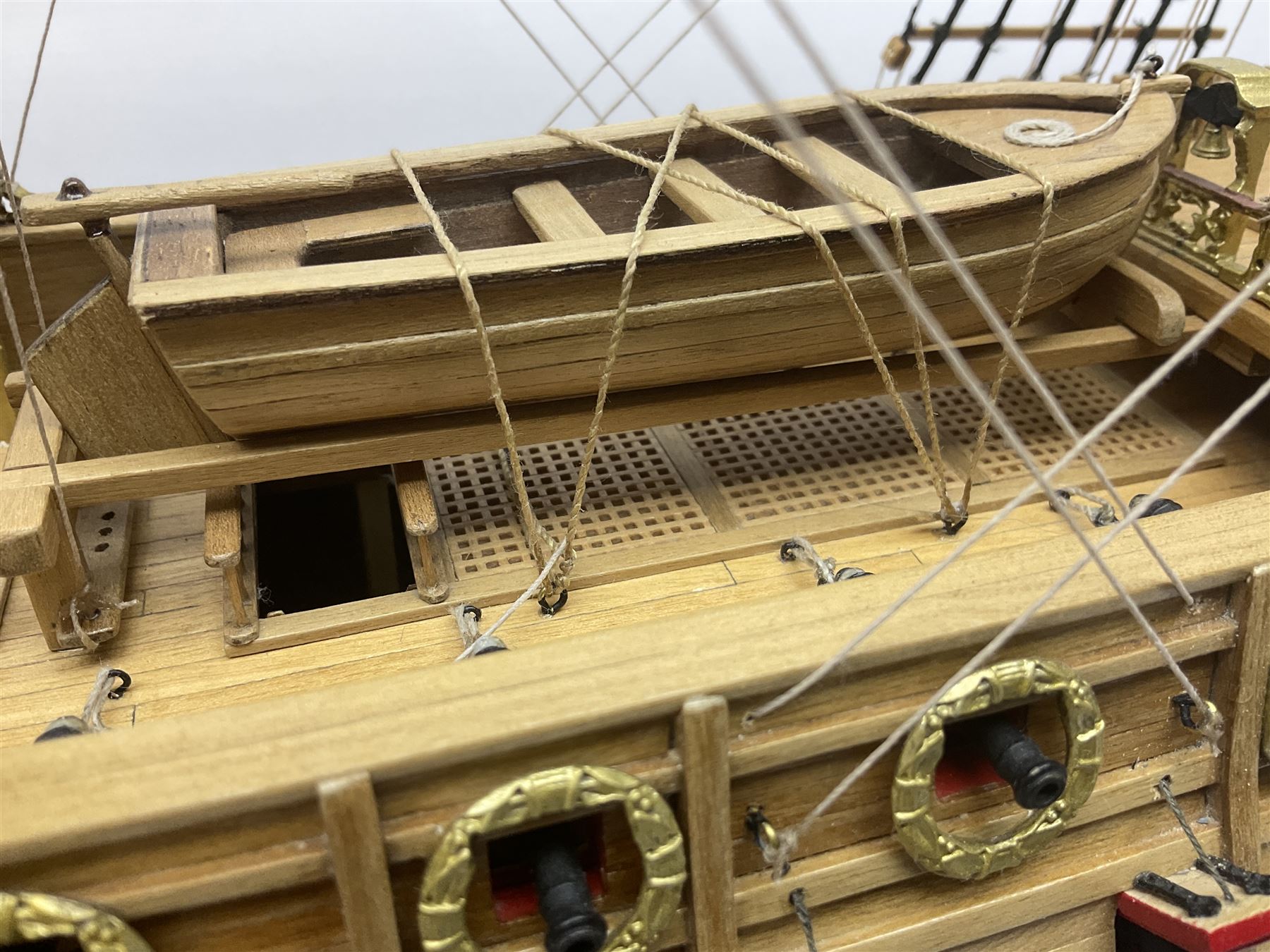 Wooden kit built model of HMS Neptune, 1:90 scale, with detailed rigging to three masts and a row of cannons to either side, upon ebonised wooden base, including stand H71cm