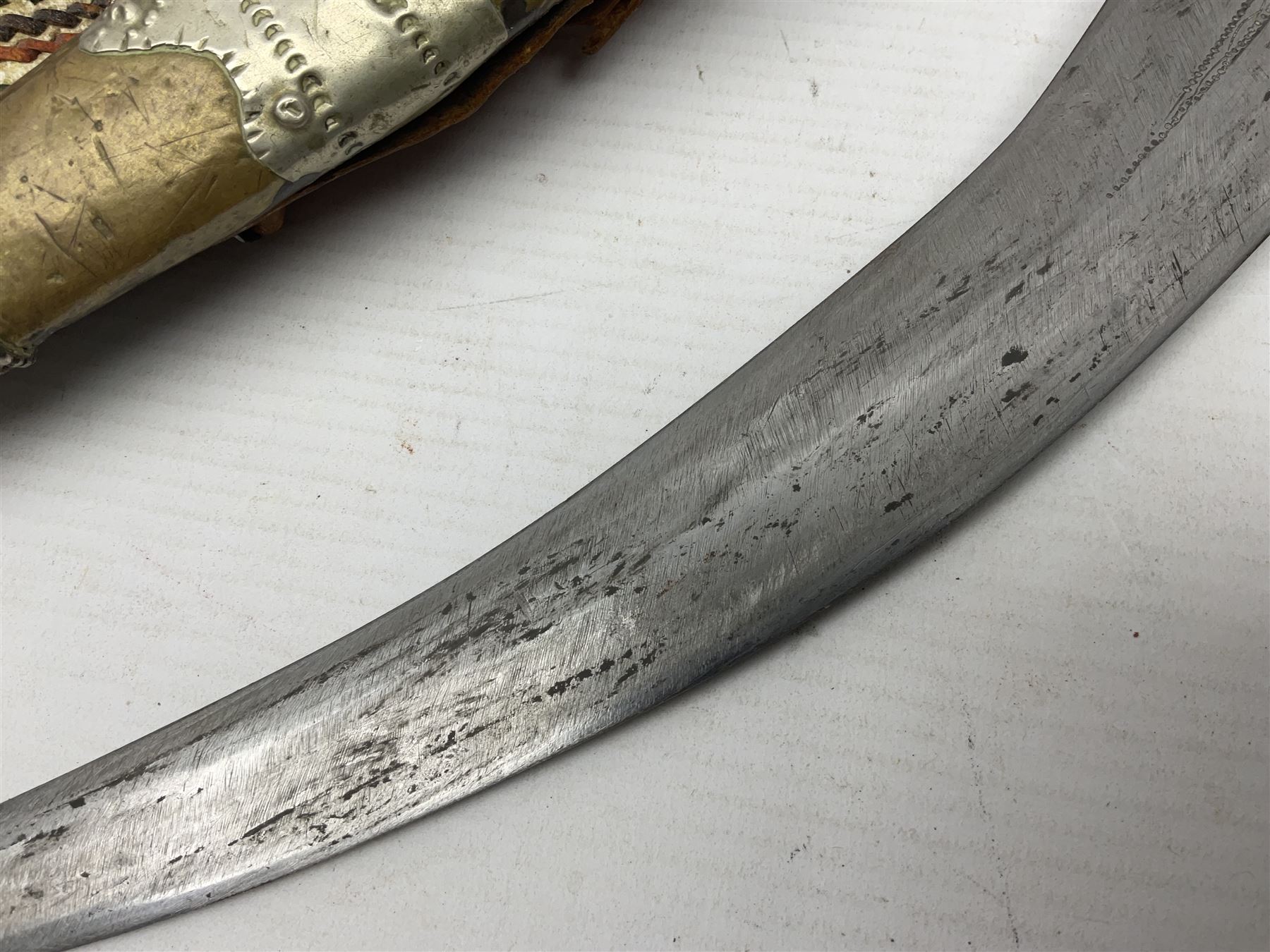 Saudi Arabian khanjar dagger with 29.5cm curving double edged  steel blade; white metal and copper mounted horn grip; in white metal mounted brass and leather scabbard incorporating embroidered leather wearing strap