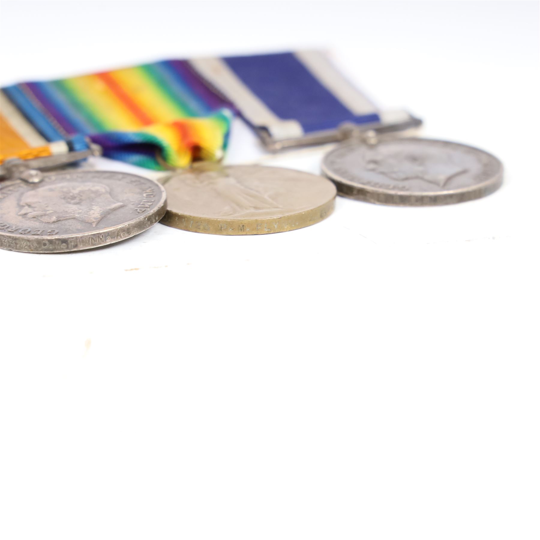 WWI Naval Long Service Group of Four Medals, comprising 1914-15 Star, British War medal, Victory Medal and Royal Naval Long Service and Good Conduct medal, awarded to J.33725, P.M.Flynn Boy.1., R.N. (later A.B. H.M.S. Queen Elizabeth)