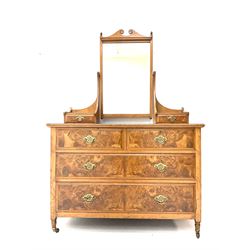 Late Victorian satin walnut and figured walnut dressing chest, raised bevelled swing mirror above to small trinket drawers, rectangular moulded top over two short and two long drawers