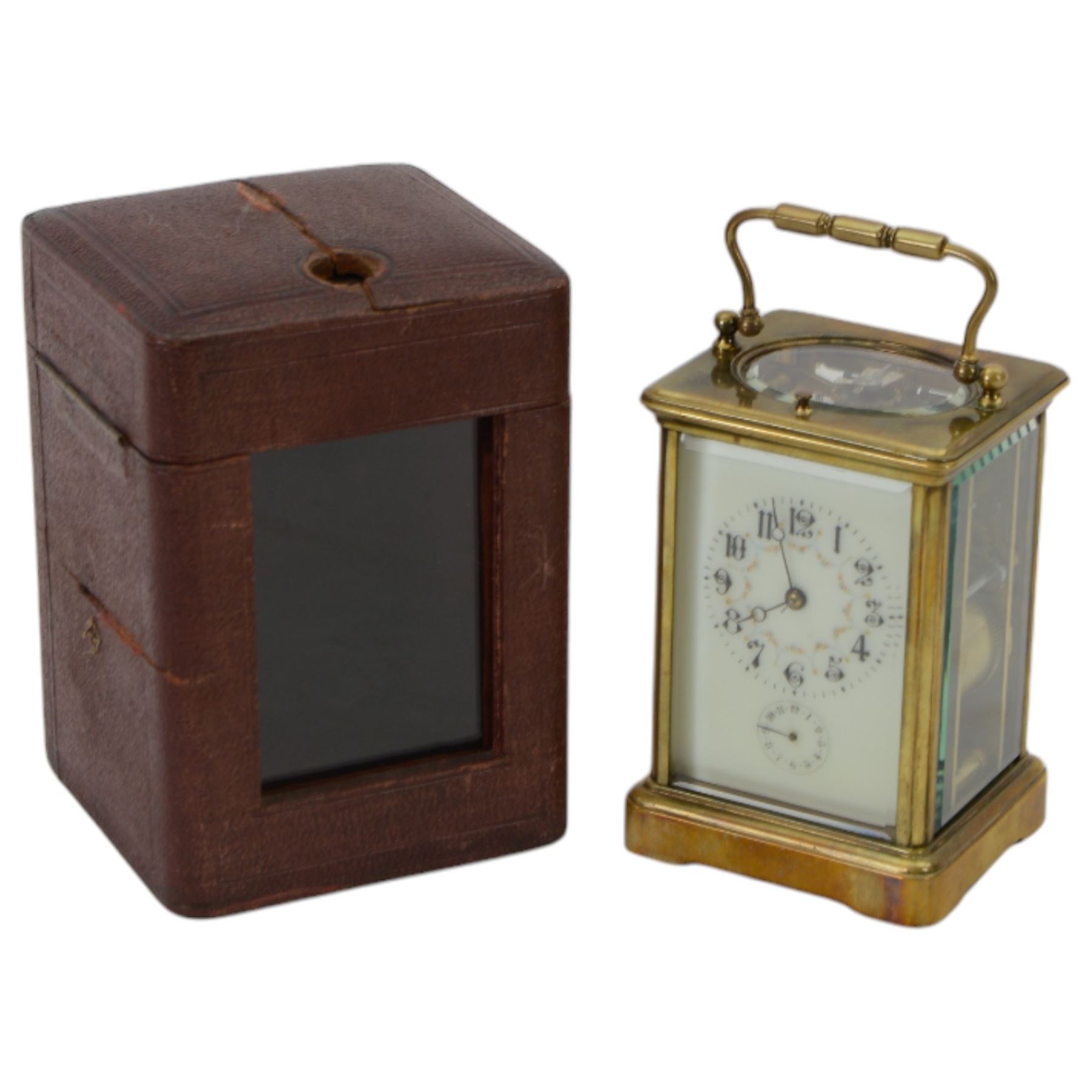 French - Early Edwardian corniche cased 8-day carriage clock, decorative enamel dial with floral garlands, Arabic numerals, minute markers, steel moon hands and conforming alarm setting dial, four rectangular glass panels and an oval viewing glass to the top, with a silvered lever platform escapement and 
timing screws to the jewelled balance, twin train rack striking movement with repeat, sounding the hours, half hours and alarm on a coiled gong.  Original traveling case with viewing glass and key.