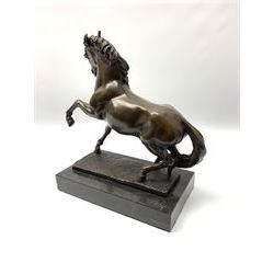 Bronze figure modelled as a prancing horse, upon a naturalistically modelled rectangular base, and black marble plinth, H34.5cm, L31cm