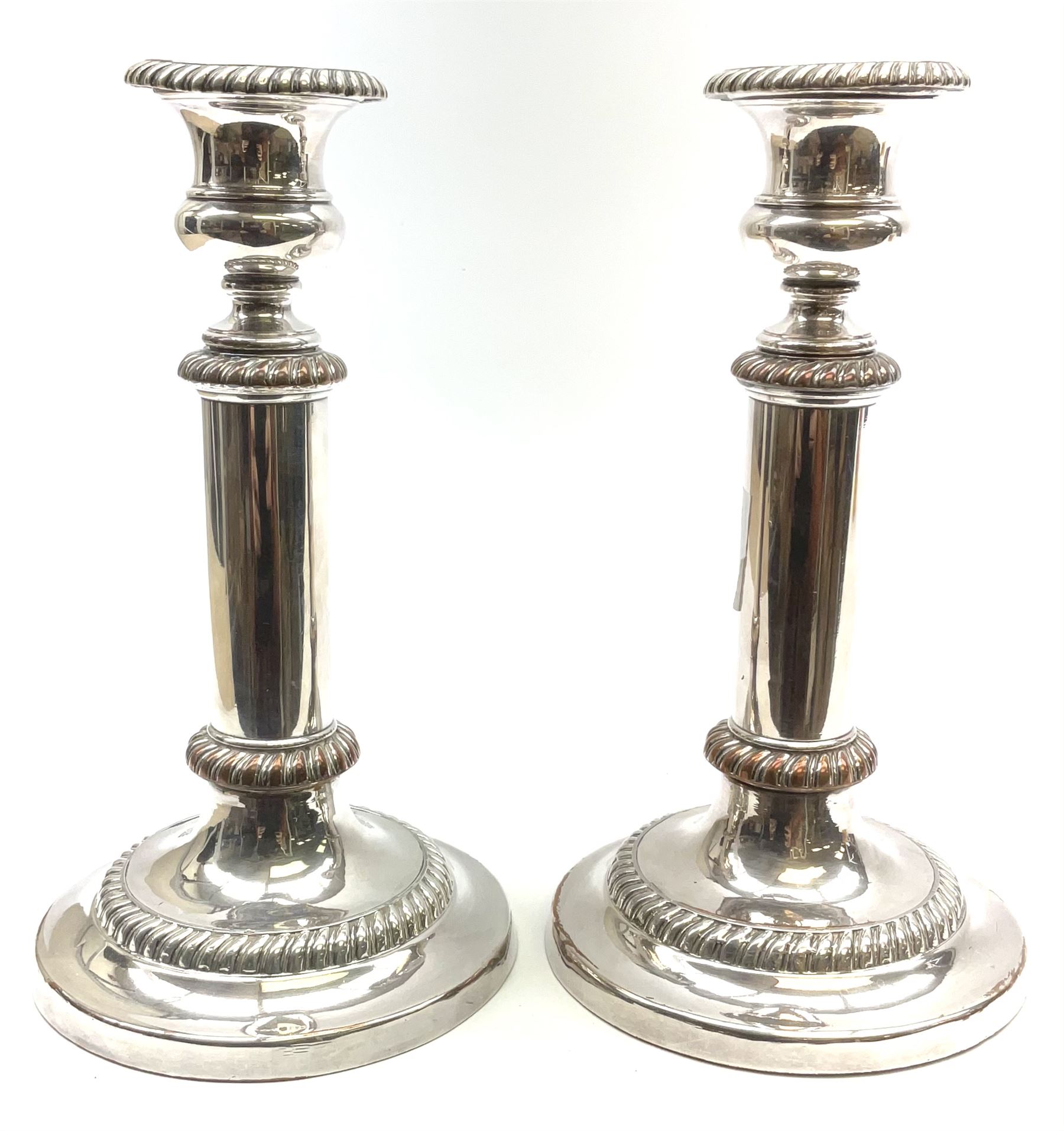 A pair of silver plated telescopic candlesticks, with gadrooned detail