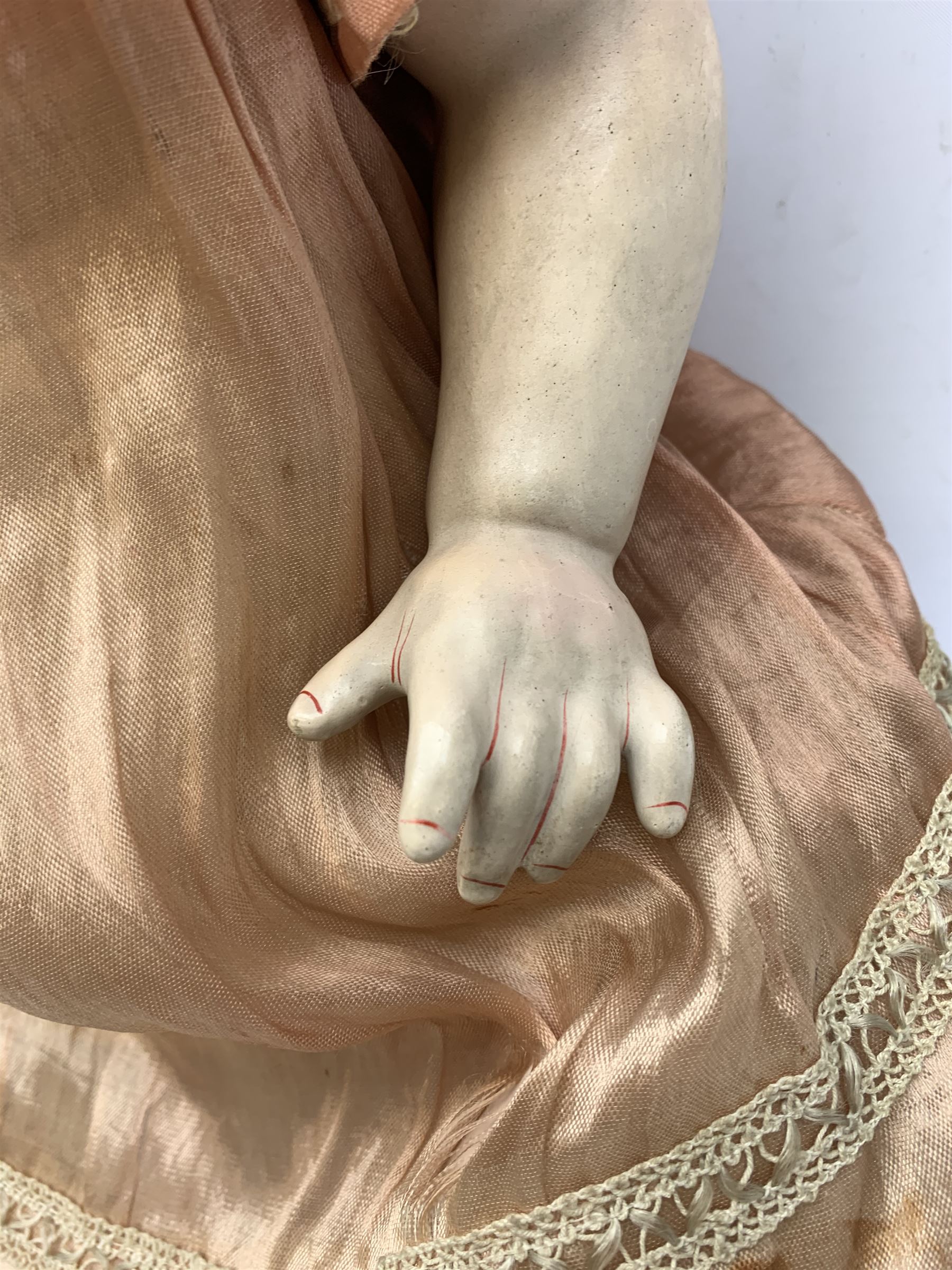 German bisque head doll with applied hair, sleeping eyes and open mouth with teeth and fixed tongue, on composition body with jointed limbs, marked 'P.M. 914 Germany 14' H65cm