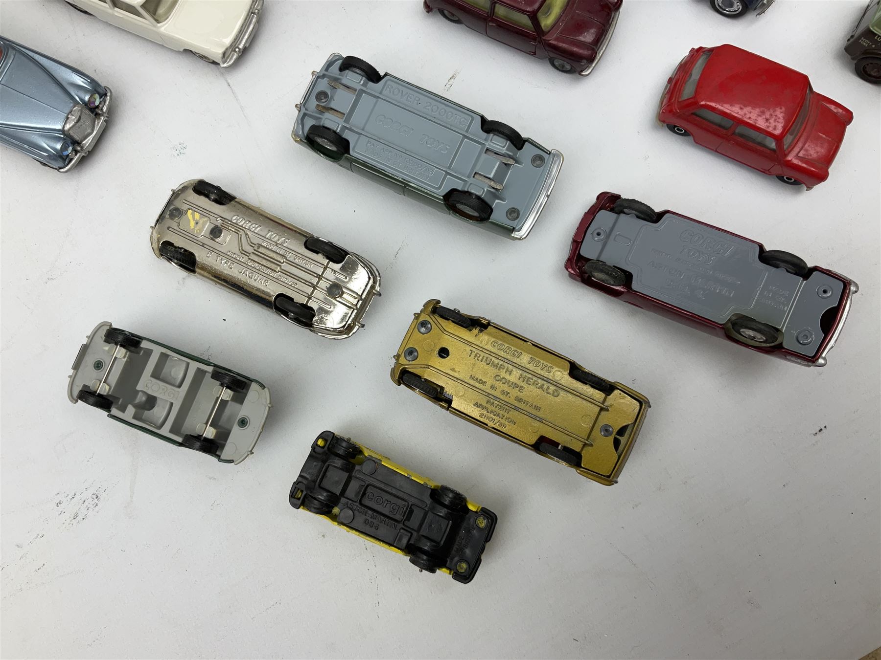 Corgi - thirty unboxed and playworn/repainted die-cast cars including Triumph Herald Coupe, BMC Mini-Cooper 'S', Porsche Carrera, two 'E' Type Jaguars, Rover 2000TC, three Morris Minors, two Aston Martin DB4, two Volvo P1800, MGA, Fiat 2100, Jaguar 2.4 Litre, Jaguar Mark X Saloon etc (30)