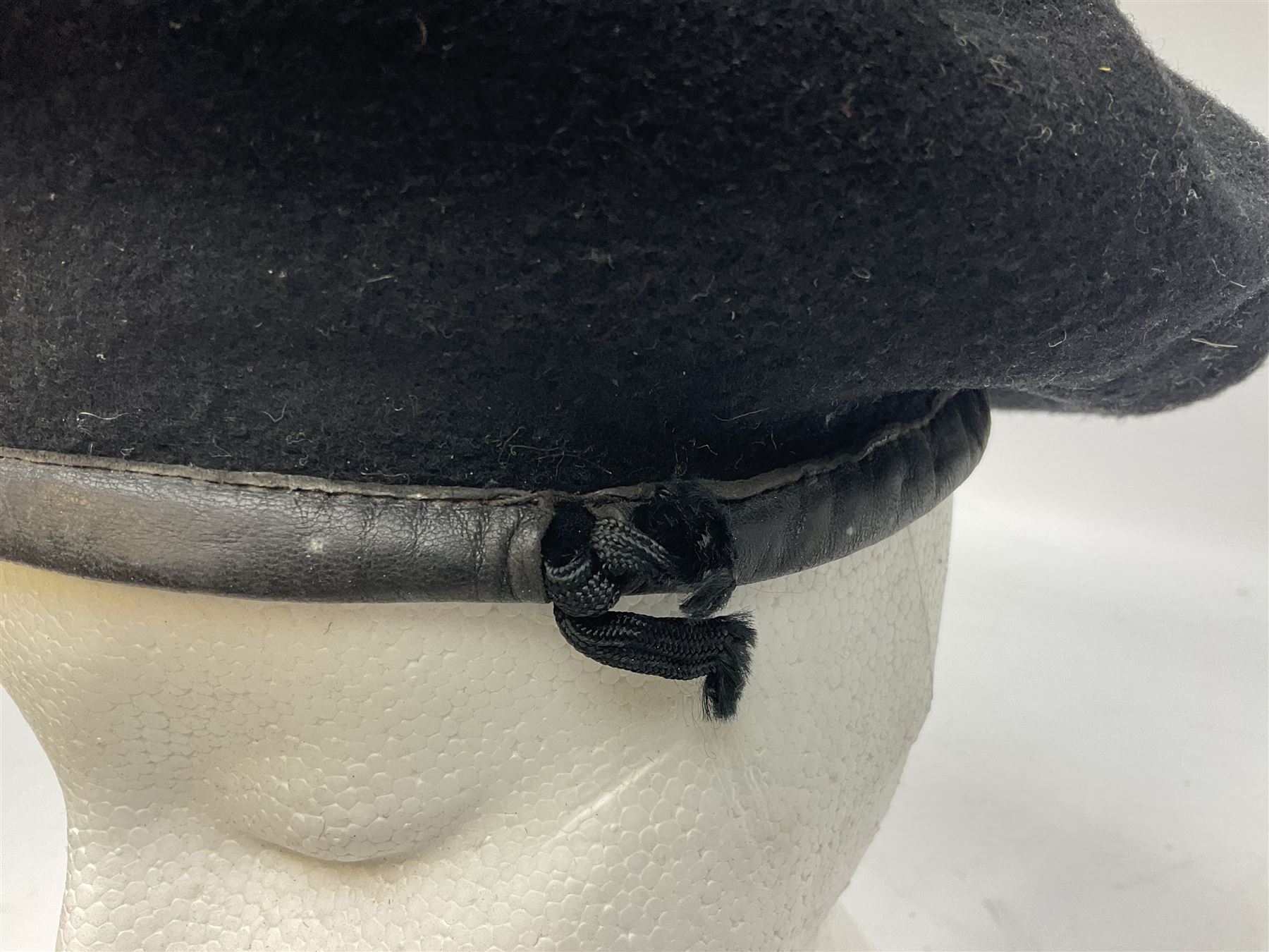 WW2 British black felt beret with Pioneer Corps cap badge, with Kangol Wear maker's mark dated 1943; and a British Army green webbing belt (2)