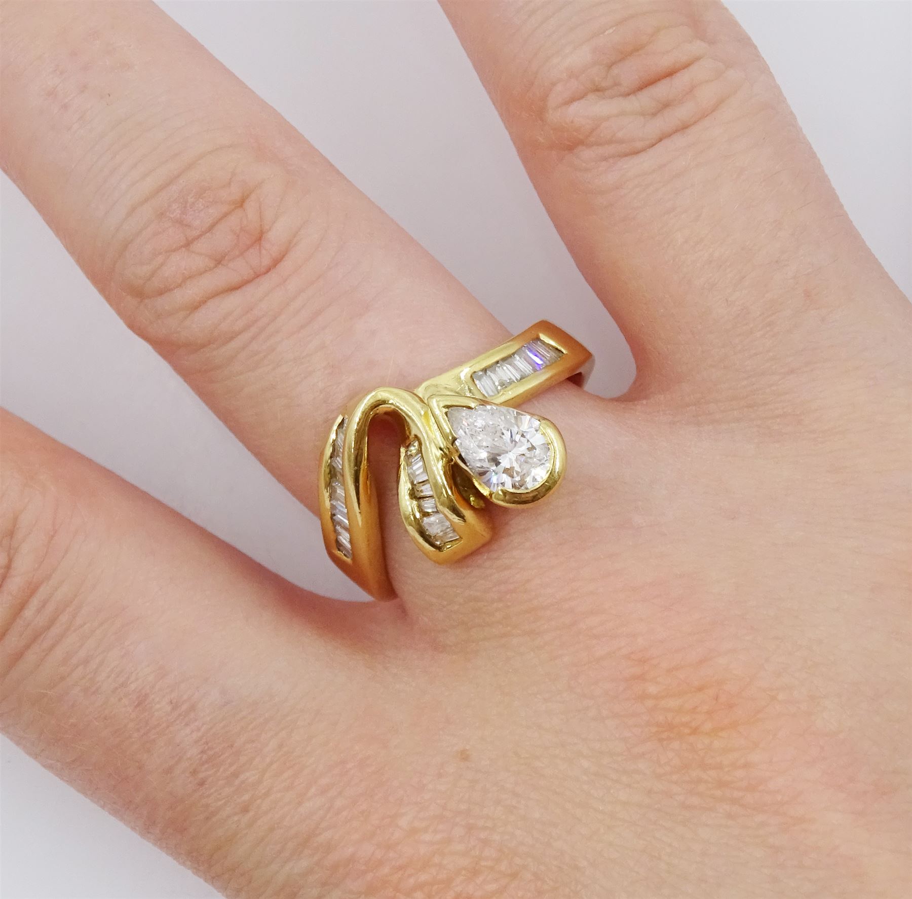 18ct gold diamond pear and baguette cut diamond ring, stamped 750, principle pear cut diamond of approx 0.75 carat, total diamond weight approx 1.25 carat