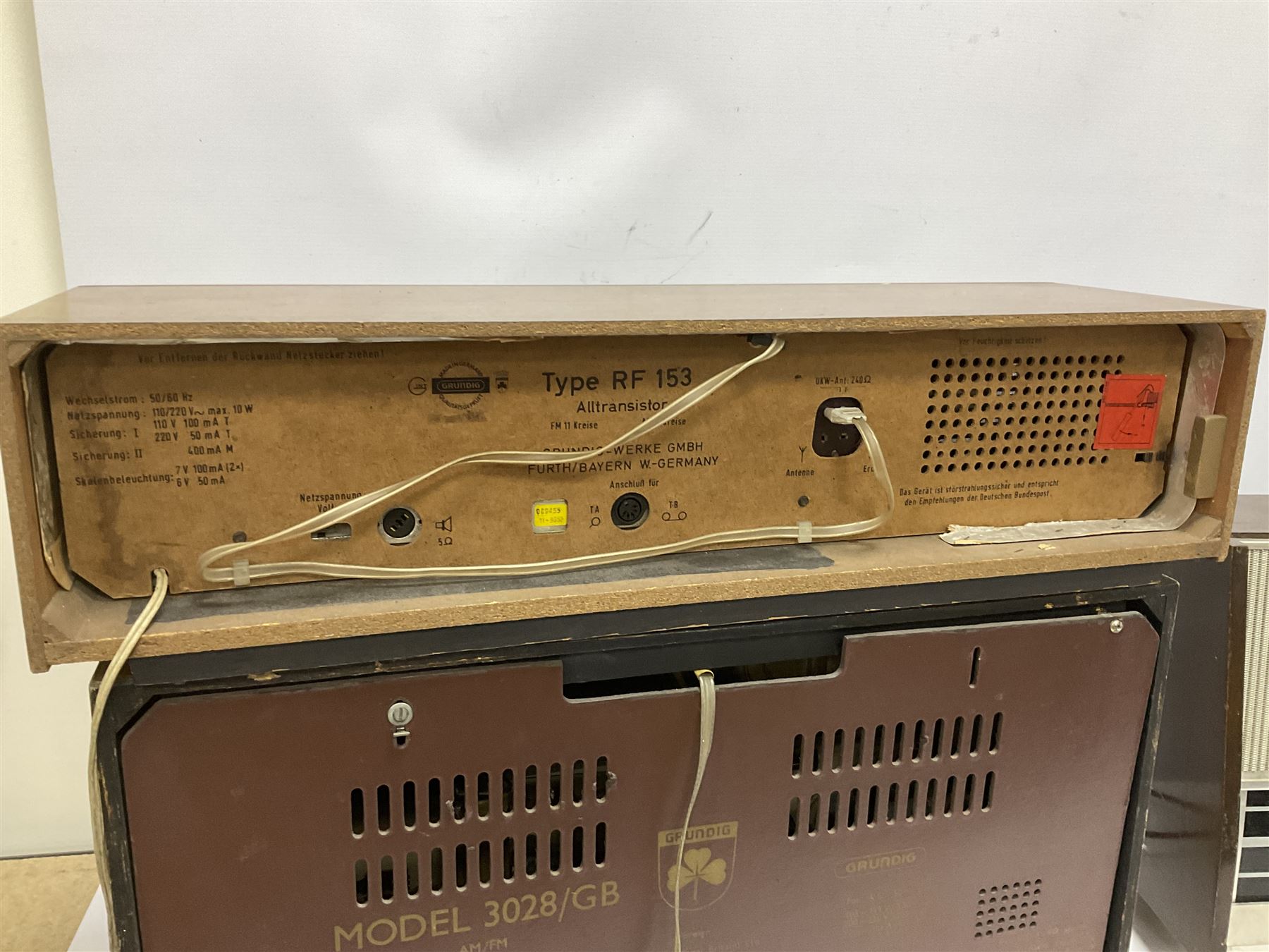 Three mid 20th century radios comprising 1950s Grundig wood cased valve radio model 3028/GB, together with a 1970s Grundig Type RF 153 CS 150 radio in teak case, and an Ekco 355 1960's valve radio, largest W60 H35cm D23cm