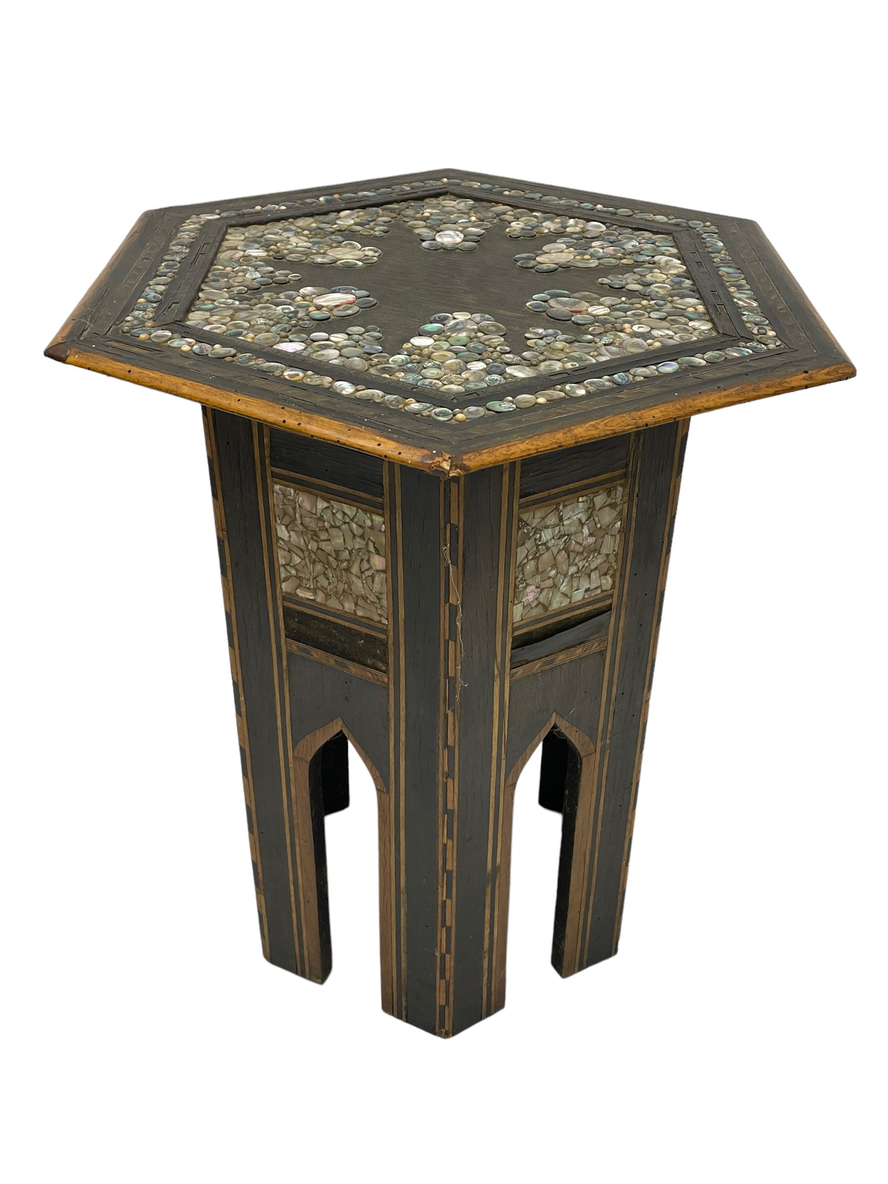 Early 20th century Anglo-Indian hexagonal table, the top decorated with mother of pearl beads and chequered banding, the base with fretwork pointed arches and inlays
