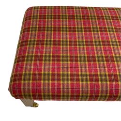 Rectangular footstool, upholstered in checkered fabric, on square tapering supports with brass castors