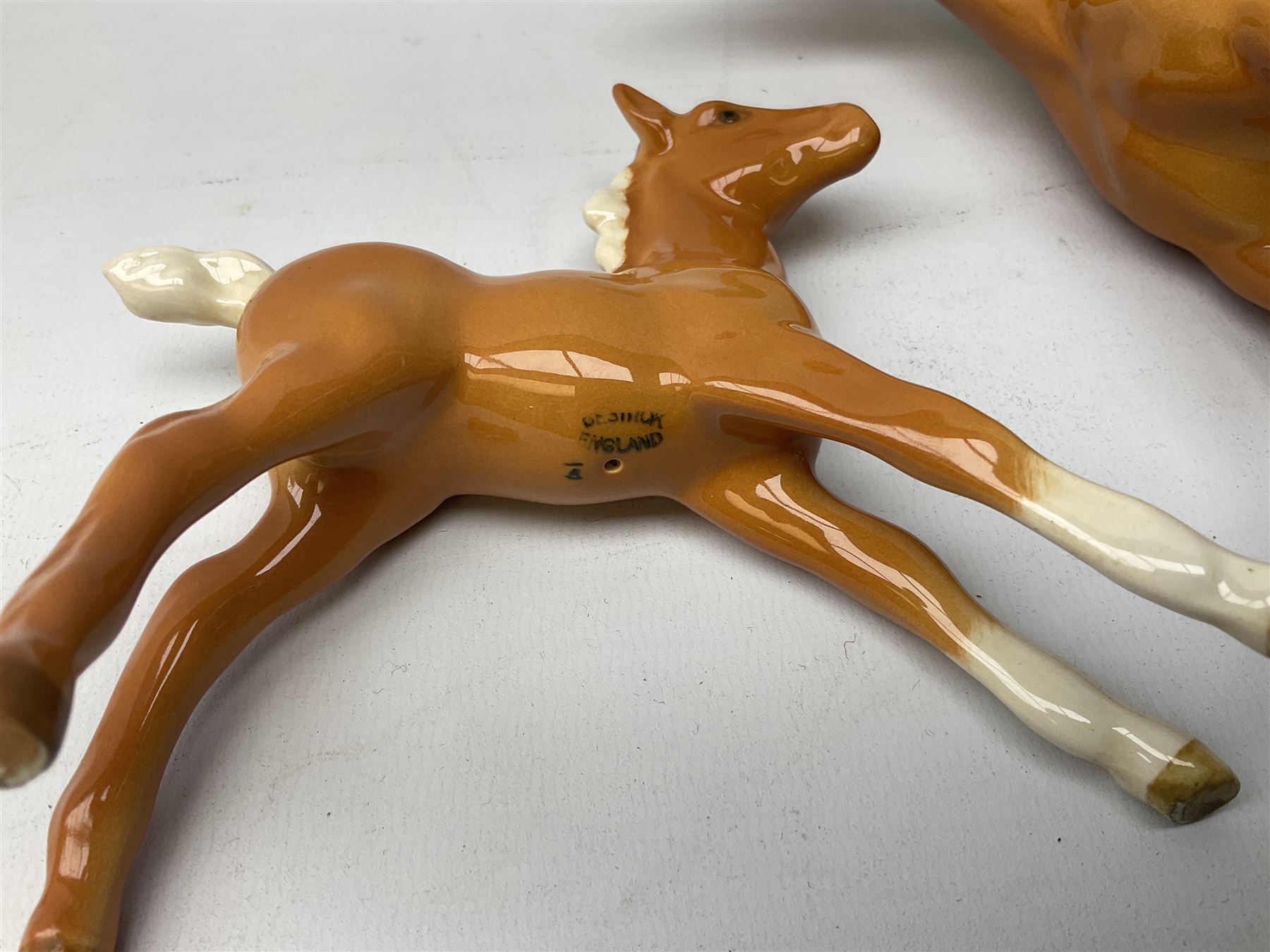 Collection of Beswick horses, including grey horse no.701, palomino foal no 836, grey stocky jogging mare no.855 etc, together two Royal Doulton horses, (8)
