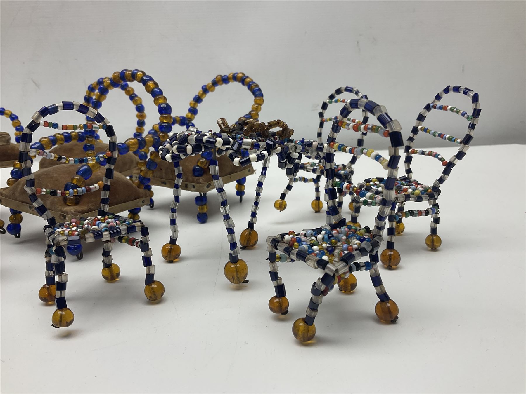 Quantity of early 20th century doll's house furniture comprising Victorian style beadwork and upholstered eight-piece salon suite; beadwork dining table with four matching chairs; and Kleeware brown plastic seven-piece dining suite