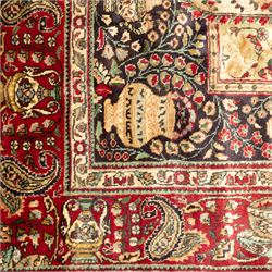 Azerbaijan rug, intricate central medallion in muted golds and greens surrounded by navy panels filled with boteh and floral designs, enclosed by a red main border featuring stylised boteh motifs, woven in the Caucasus region of Azerbaijan