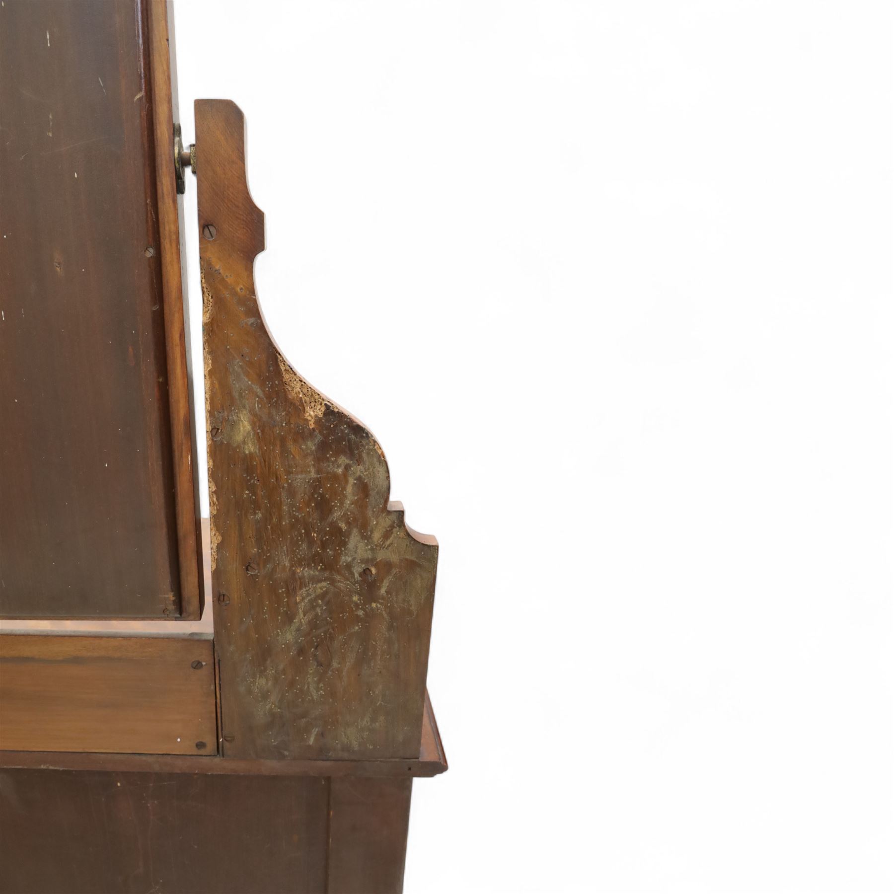 Edwardian walnut dressing chest, rectangular top surmounted by a mirror frame with shaped pediment on swing supports above two short frieze drawers over two short and three long graduated drawers fitted with brass foliate handles, raised on a plinth base