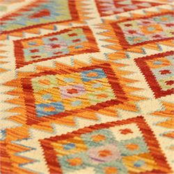 Two Chobi Kilim flatweave rugs, comprising the largest kilim on a cream ground with a grid of stepped diamond medallions in a palette of rust red, turquoise, green, ochre, and lilac,, filled lozenge motifs, framed by a cream ground border, 148x101cm, Chobi Kilim with multi-stepped diamond medallion with serrated bands, in terracotta, turquoise, green, saffron and blue, framed by a broad polychromed border of stylized guls and narrow guard stripes, 114x87cm 