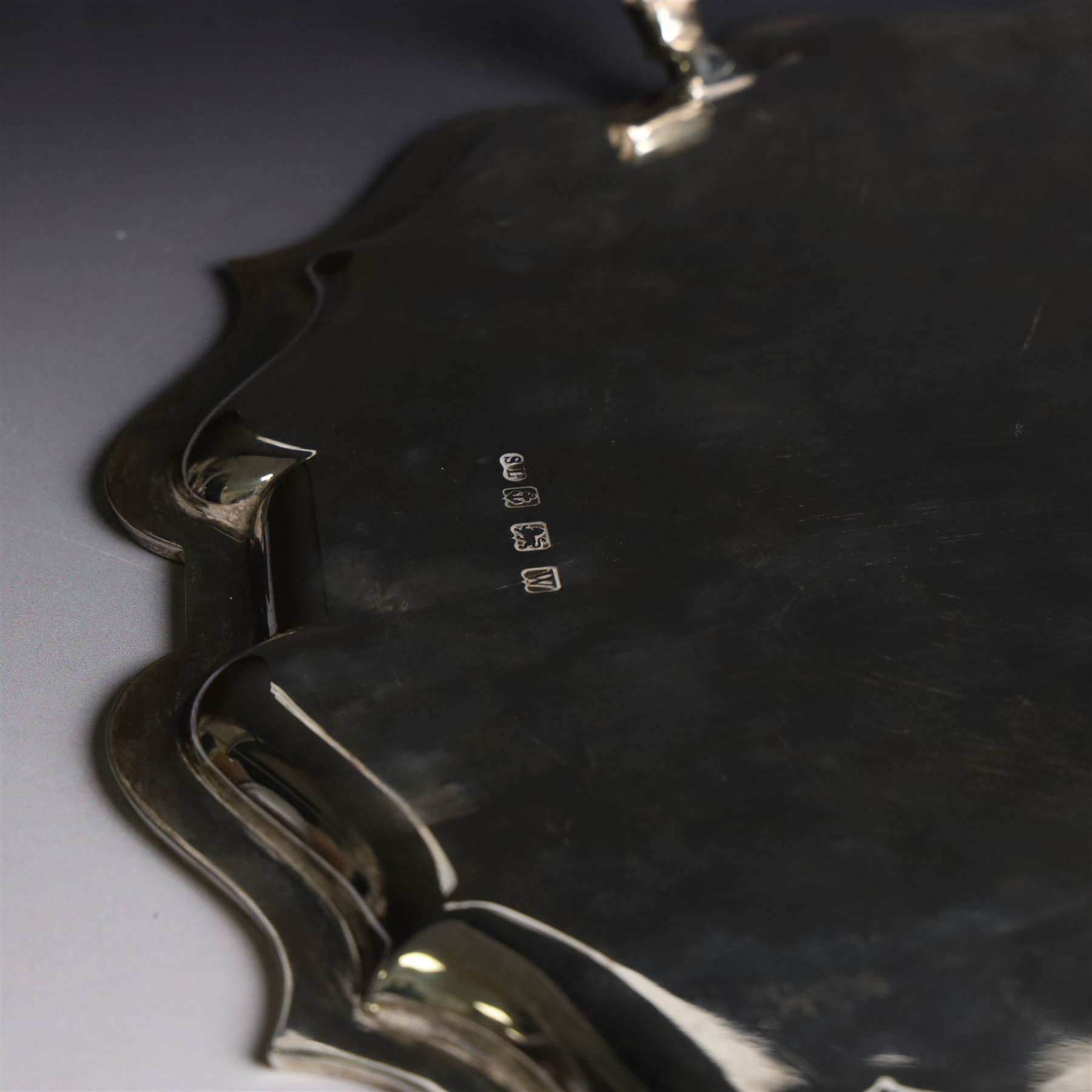 Mid 20th century silver tray, with shaped rim and upon three scroll feet, William Suckling Ltd, Birmingham 1946, D36cm