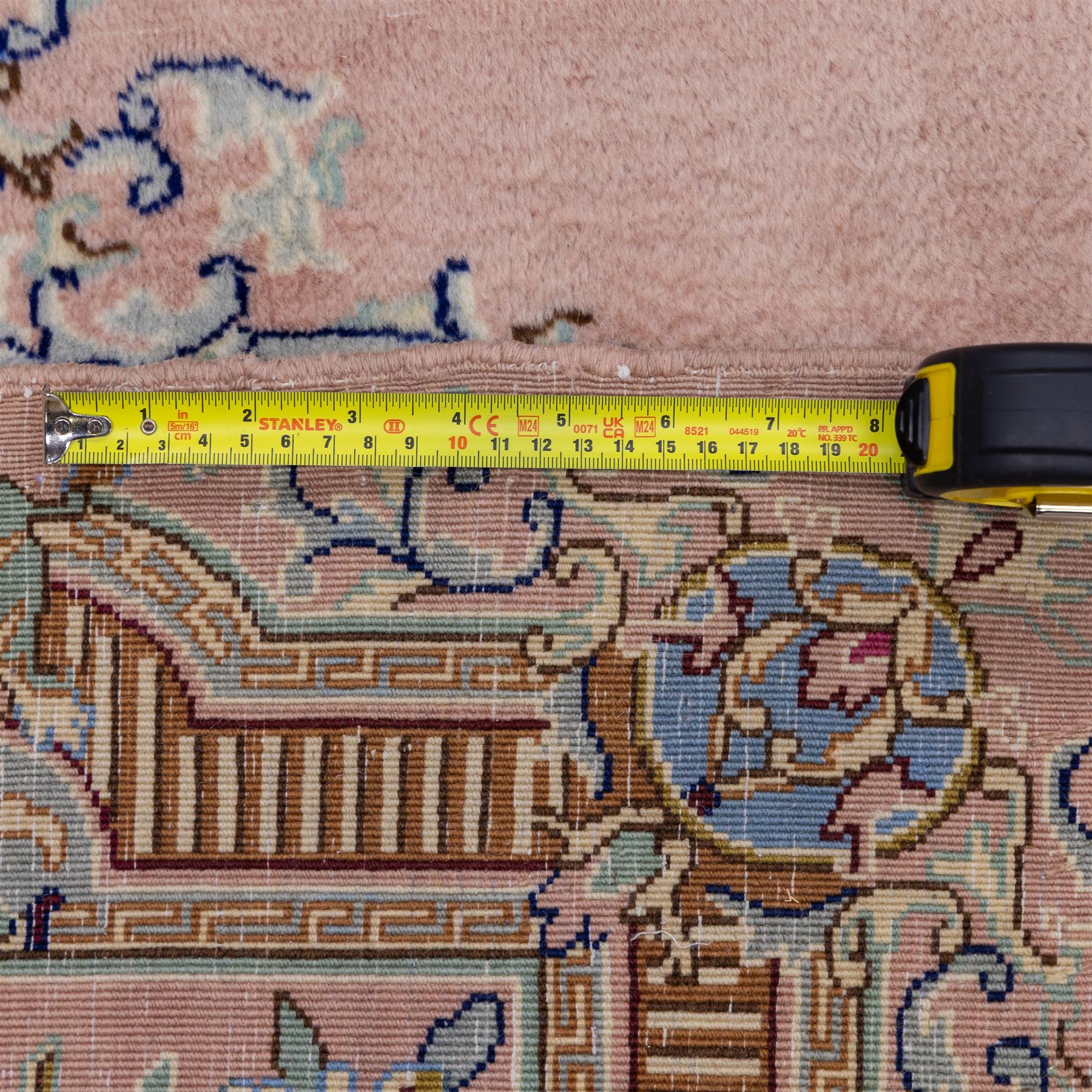 South East Persian Kirman hand-knotted rug, pale blush field with central scalloped medallion within an elaborate scalloped cartouche, spandrels filled with fine scrolling vine-work, palmettes and floral sprays, enclosed by wide and narrow borders in soft tones of blush pink, ivory, powder blue, sage green and pale gold, with cotton fringe ends 