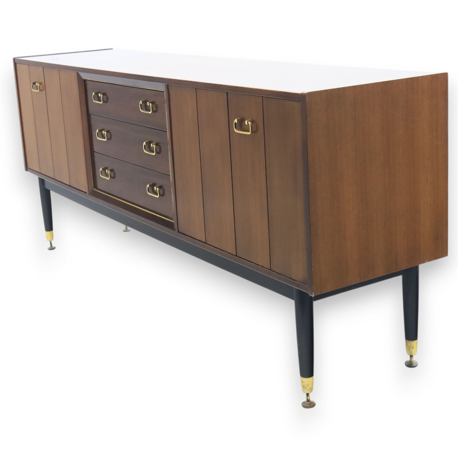 G Plan - ‘Librenza’ tola wood sideboard, the rectangular top above two cupboards to either side and three graduated central drawers, the drawer and door fronts veneered in figured tola wood with brass handles, standing on splayed tapering legs