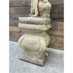 Cast stone garden statue of partially draped classical female figure on ornate pedestal 