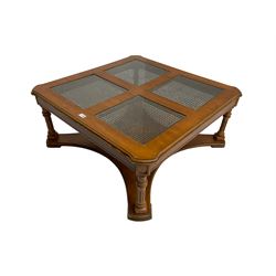 Coffee table, square top with cane work insets, raised on four fluted column supports joined by shaped base