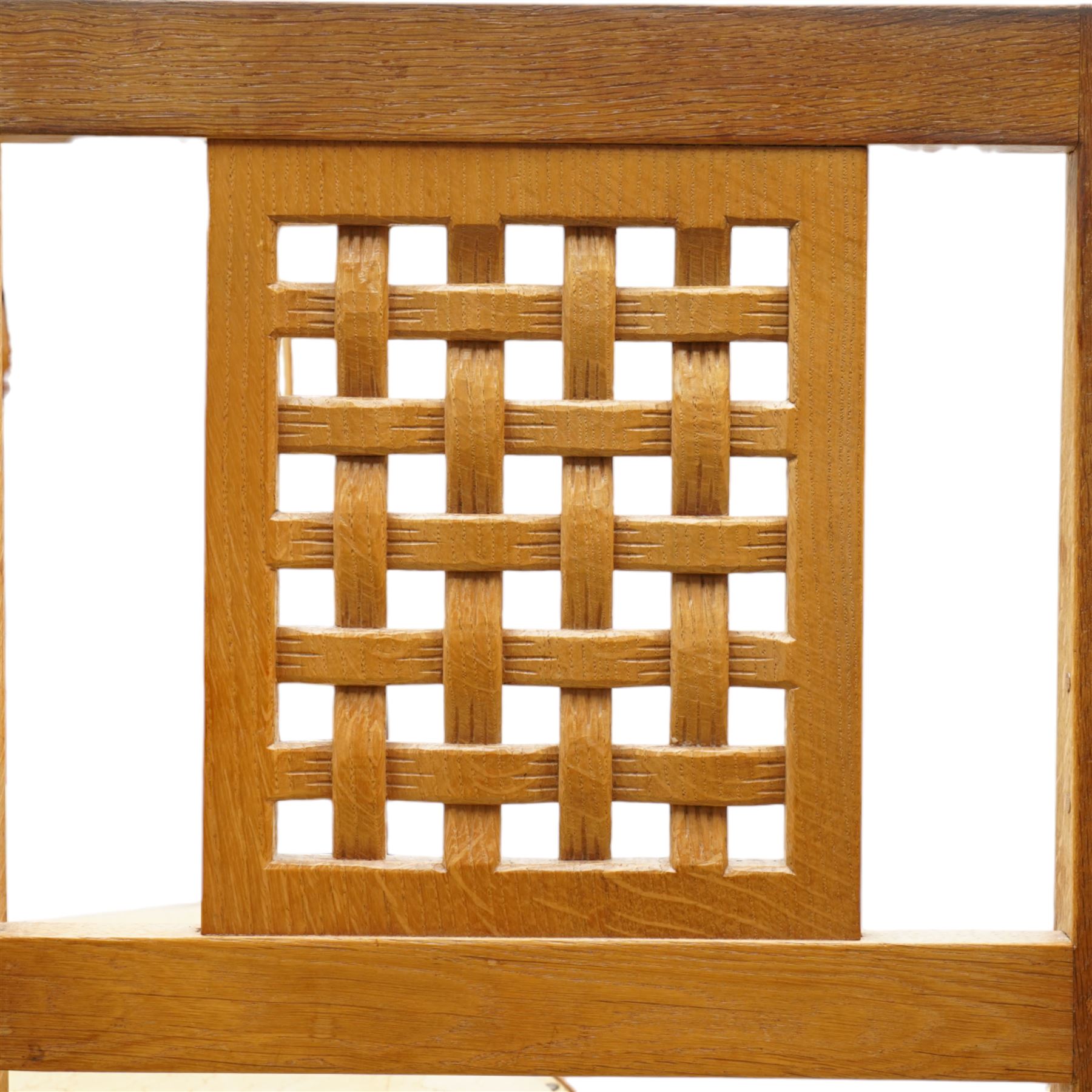 Mouseman - set of six (4+2) oak dining chairs, pierced and carved lattice back over leather upholstered seat, on octagonal front supports united by stretchers, carved with mouse signature, by the workshop of Robert Thompson, Kilburn