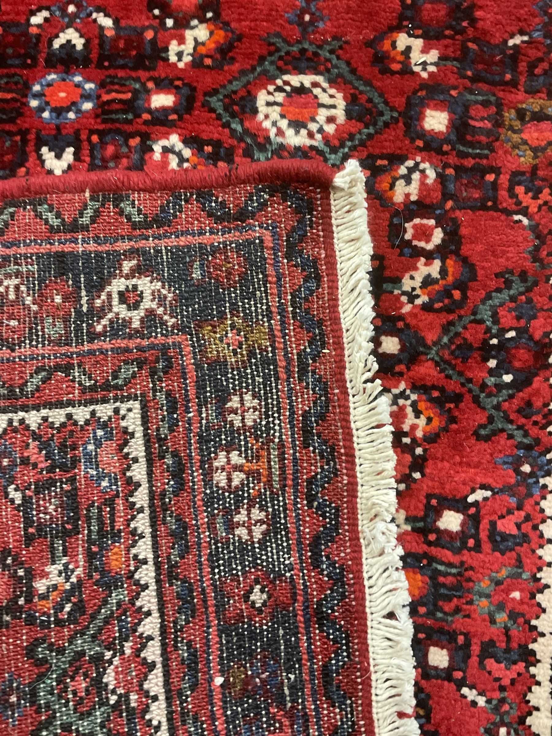 North West Persian Malayer runner, red ground field decorated with Herati motifs, guarded border decorated with trailing flowerhead band 