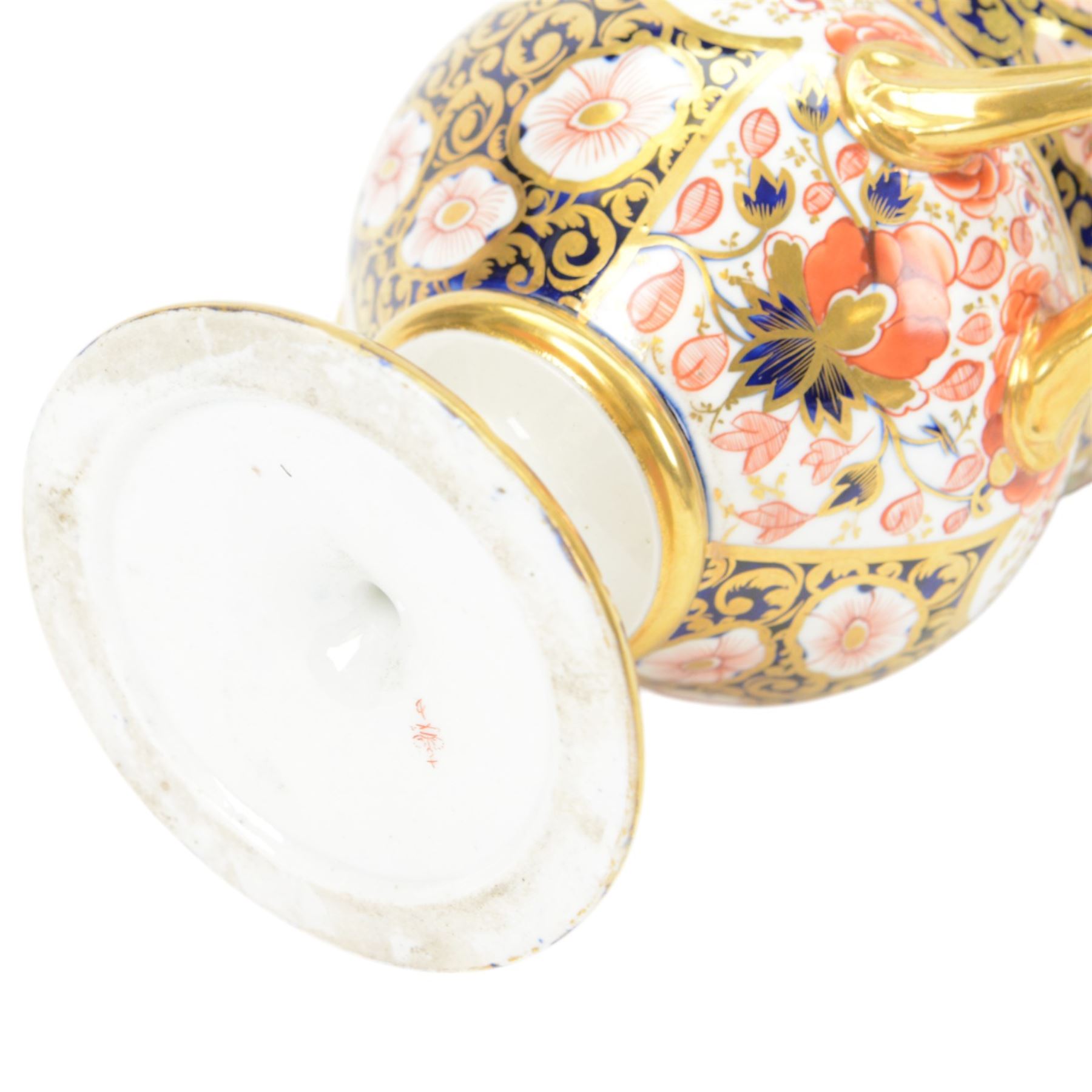 Royal Crown Derby campana vase, decorated in imari pattern, with gilt handled upon a circular base, with mark beneath, H22cm