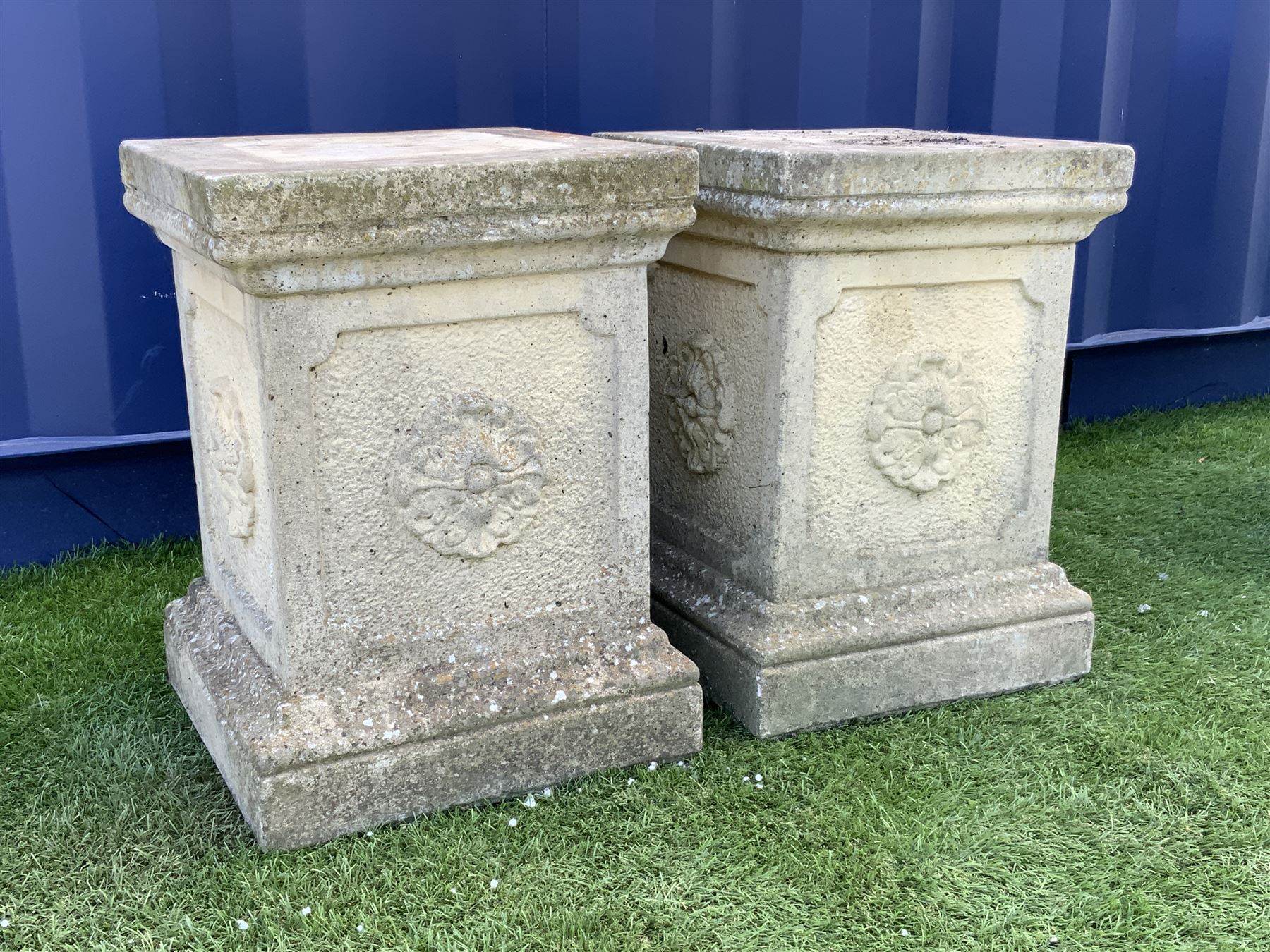 Pair composite stone garden plinths, square form with top and lower mould, each side set with flower head - THIS LOT IS TO BE COLLECTED BY APPOINTMENT FROM DUGGLEBY STORAGE, GREAT HILL, EASTFIELD, SCARBOROUGH, YO11 3TX