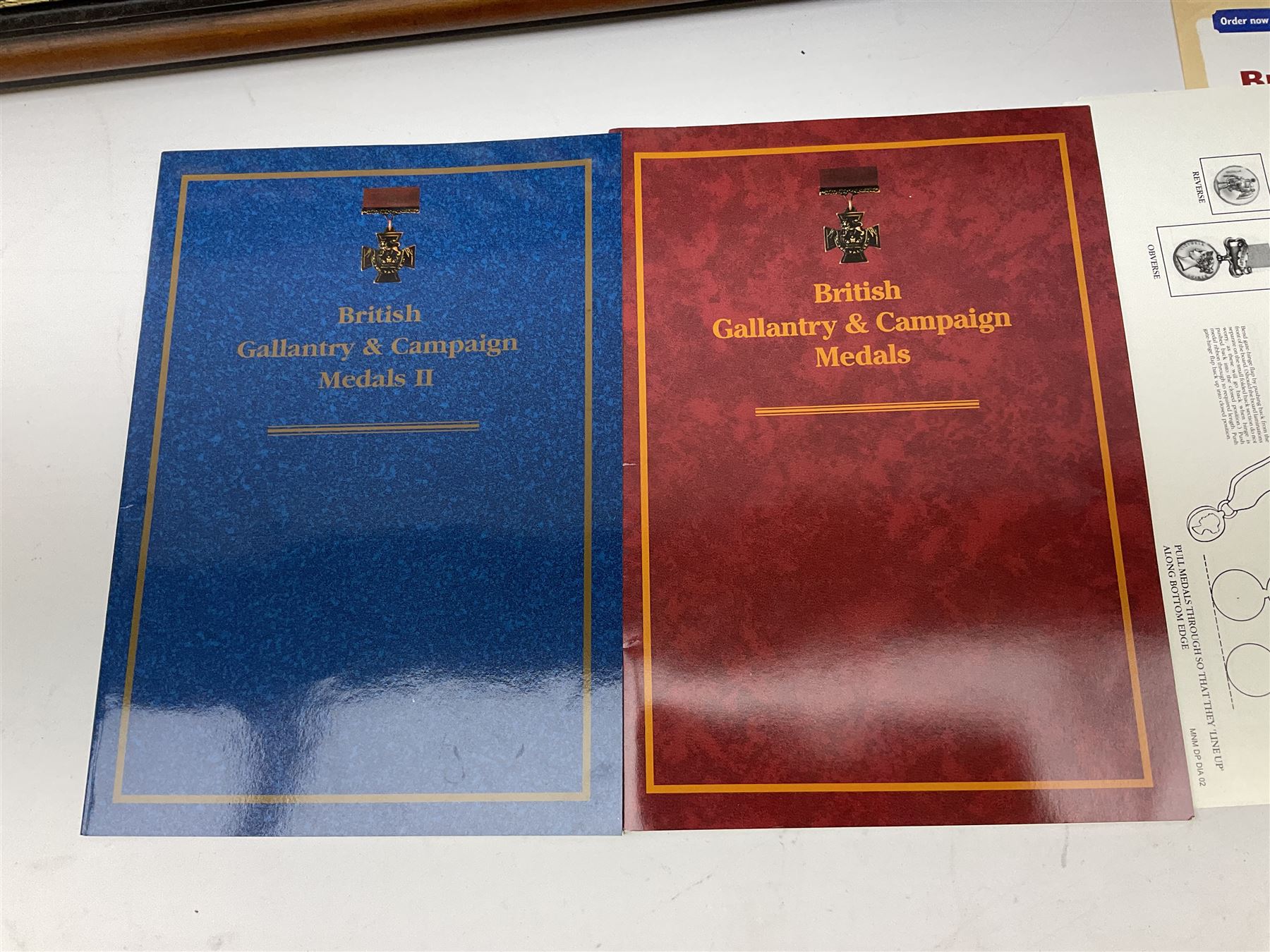 Two limited edition large framed display boards with half-size copies of British Gallantry and Campaign Medals produced by Danbury Mint and entitled 'For Valour'. Sixty medals on each board, all with ribbons. Complete with Danbury Mint certificate serial number A0148 and other paperwork.