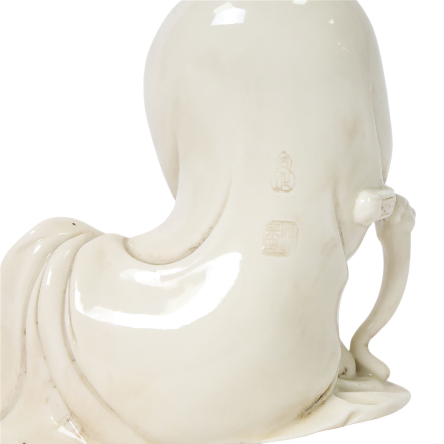 Three Chinese blanc de chine, each depicting Guanyin seated, Dehua province, two with double gourd and potters seal marks to the reverse 