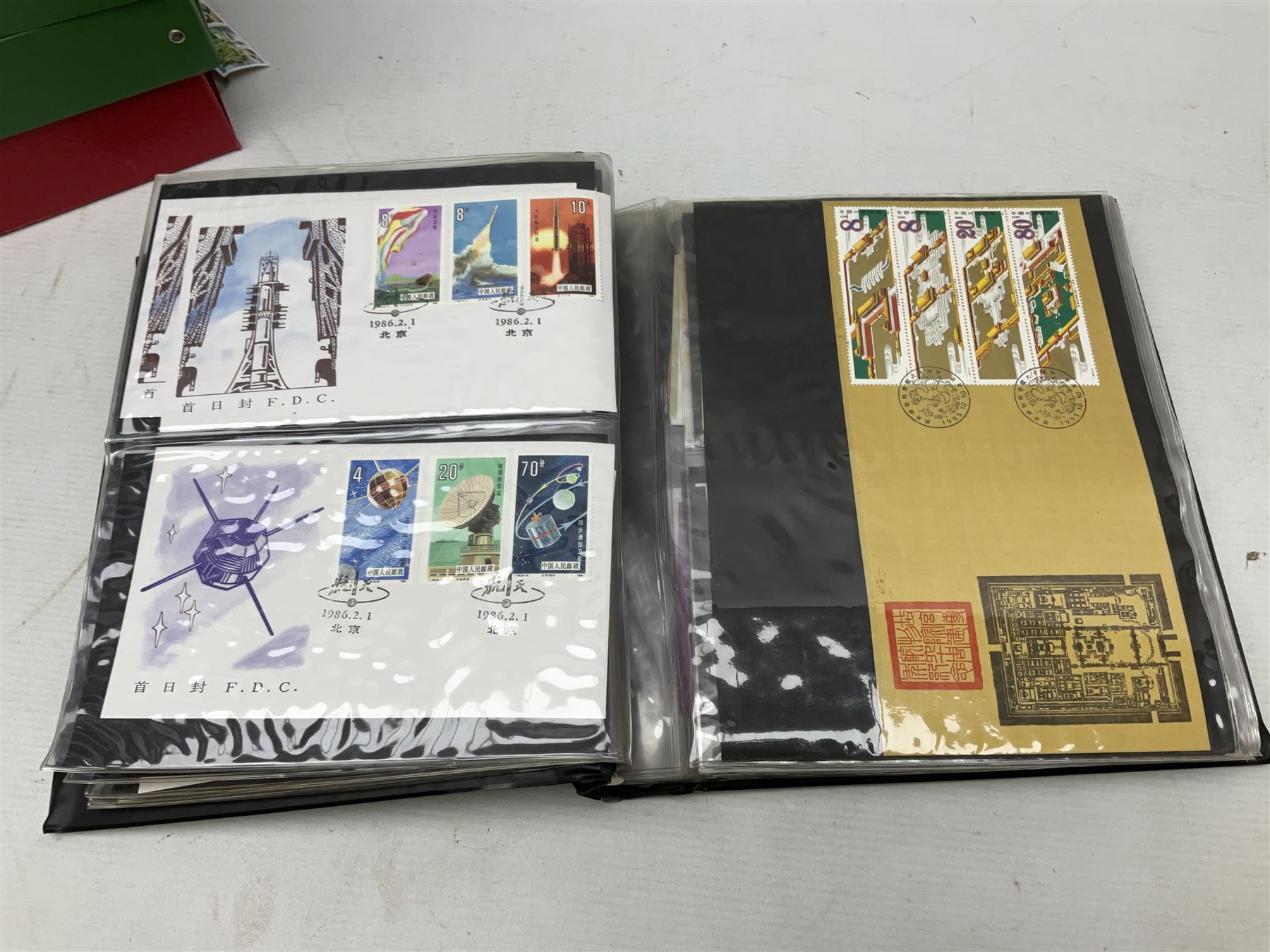 Mostly Chinese stamps including  covers and postcards, many being from the 80s and 90s, housed in ten folders