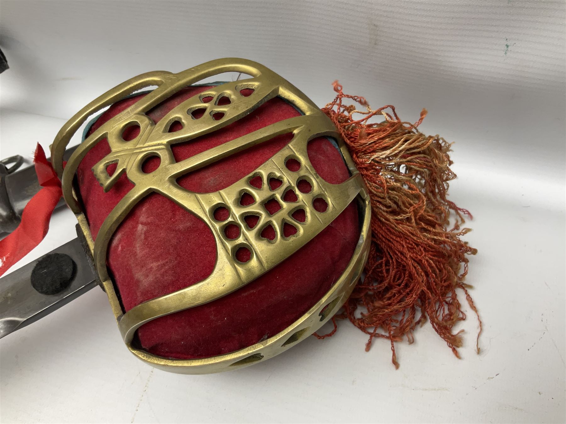 Reproduction Scottish officers basket hilt broad sword, the brass basket pierced with heart-shaped motifs lined with red lining, together with a reproduction Japanese Katana sword, longest L110cm