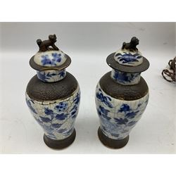 Pair of early 20th century Chinese crackle glaze vases of baluster form decorated with birds and blossoming branches, the covers having dog of Fo knops, H22.5cm, together with a Japanese table lamp of ovoid form, decorated with samurai fighting on horseback, 