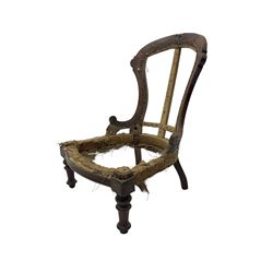 Late Victorian walnut and beech framed nursing chair, with carved scroll decoration, on turned supports 