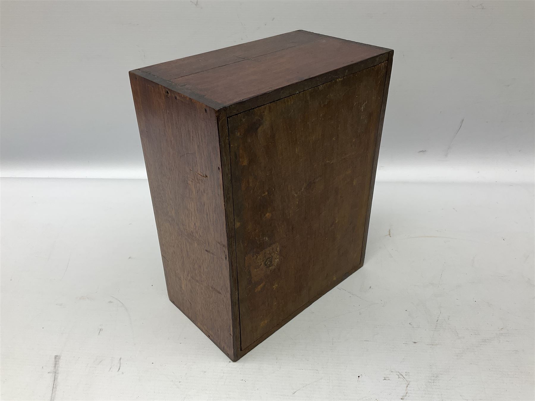 Taxidermy: Cased Red Squirrel (Sciurus vulgaris), mounted upon naturalistic ground works, set against a white backdrop, encased within a single panel display case, H28cm