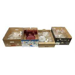 Quantity of glassware to include cranberry glass, Stuart pedestal dish, decanters etc in four boxes