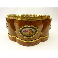  Late 19th/ early 20th century French kingwood two handled jardiniere of quatrefoil form with foliate gilt metal mounts, two porcelain panels hand painted in the Sevres style with a winged cherub and floral sprays below a pierced gallery, with removable tin liner, L36cm x H17cm x D25cm. Provenance Property of Bob Heath, Brandesburton Formerly of Ravenfield Hall Farm near Rotherham  